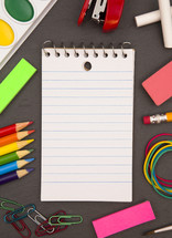 school supplies and lined paper notepad 