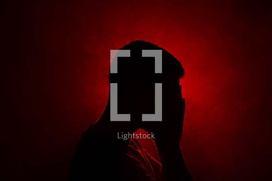 silhouette of a man covered his face 