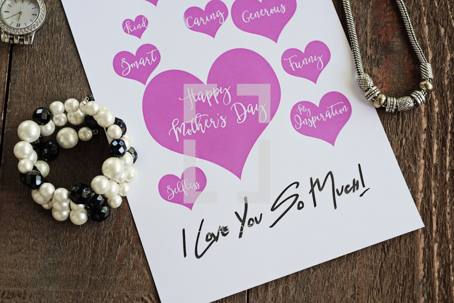 mother's day card and jewelry on a table 