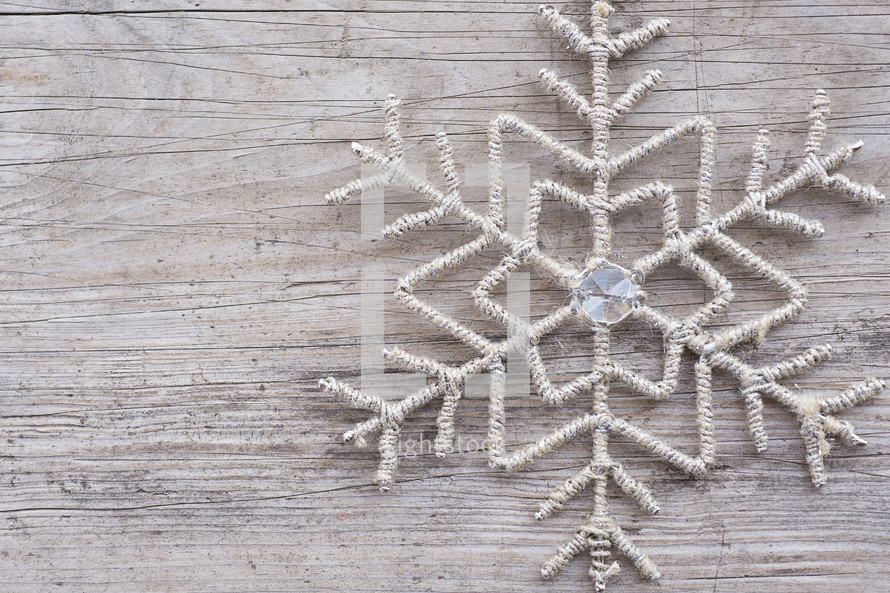 snowflake decor on wood background 