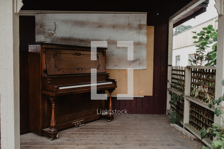 quaint old piano on wooden stage