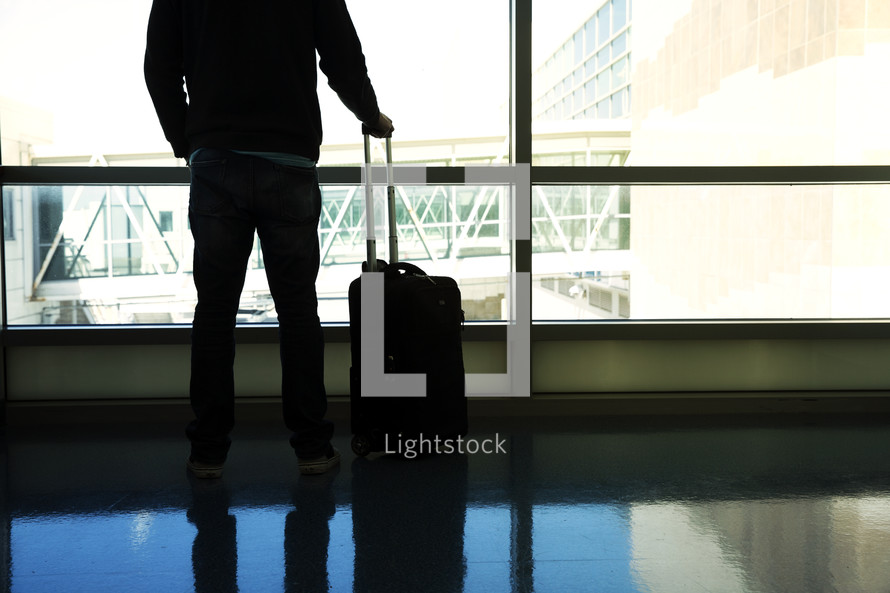 a man with luggage in an airport 