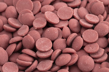 Authentic Ruby Chocolate Drops on a white Counter