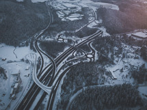 aerial view over highways in winter snow 