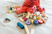 toddler girl playing with building blocks 