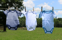 onesies drying on a clothesline 
