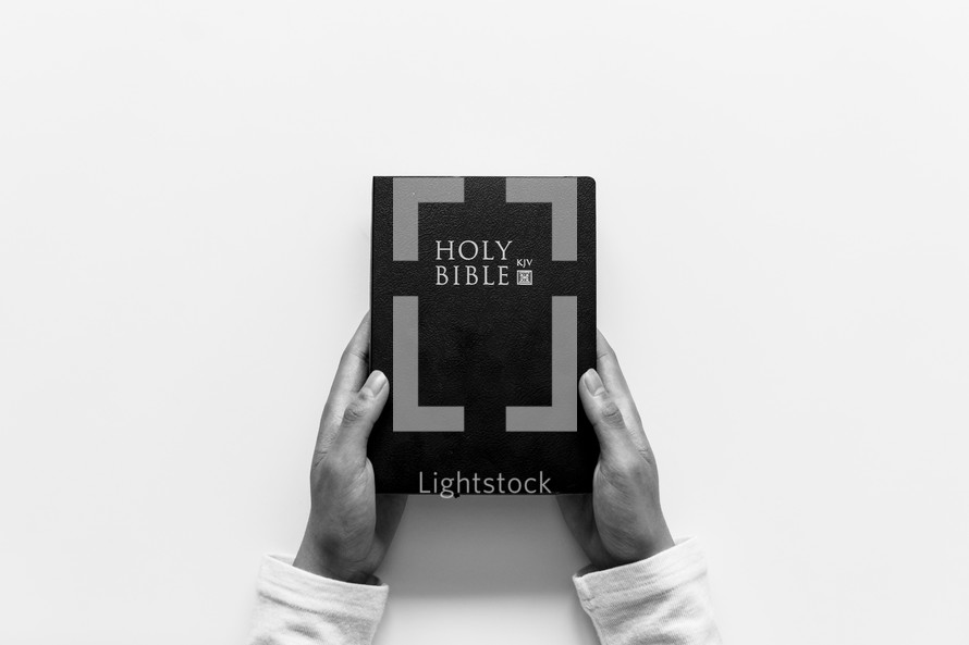 hands holding a Holy Bible 
