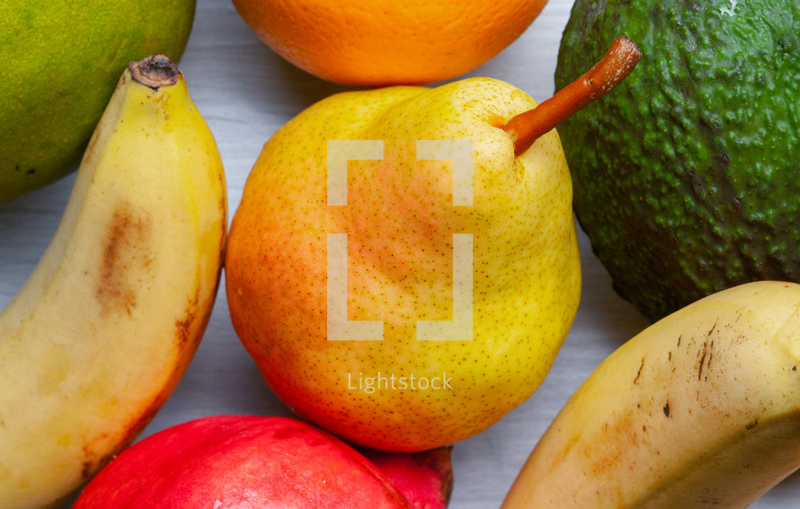 Pear, orange, red apple and banana are mixed tasty fruit composition on background fruit health food