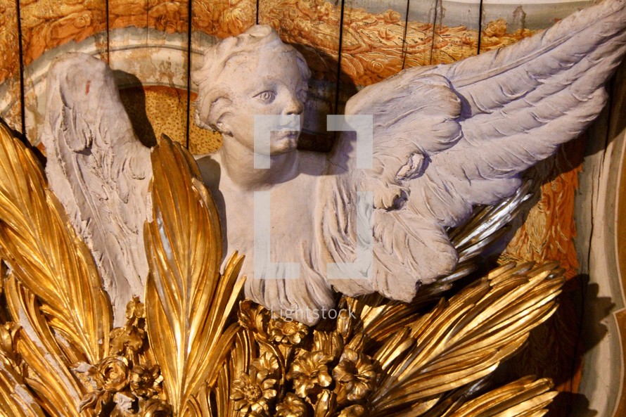 angel statue with golden feathers 