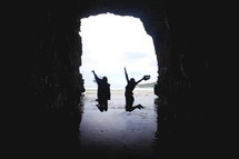 jumping in a cave on a beach 