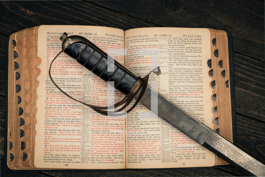 a sword on the pages of a Bible 