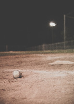 baseball on a baseball field at night 