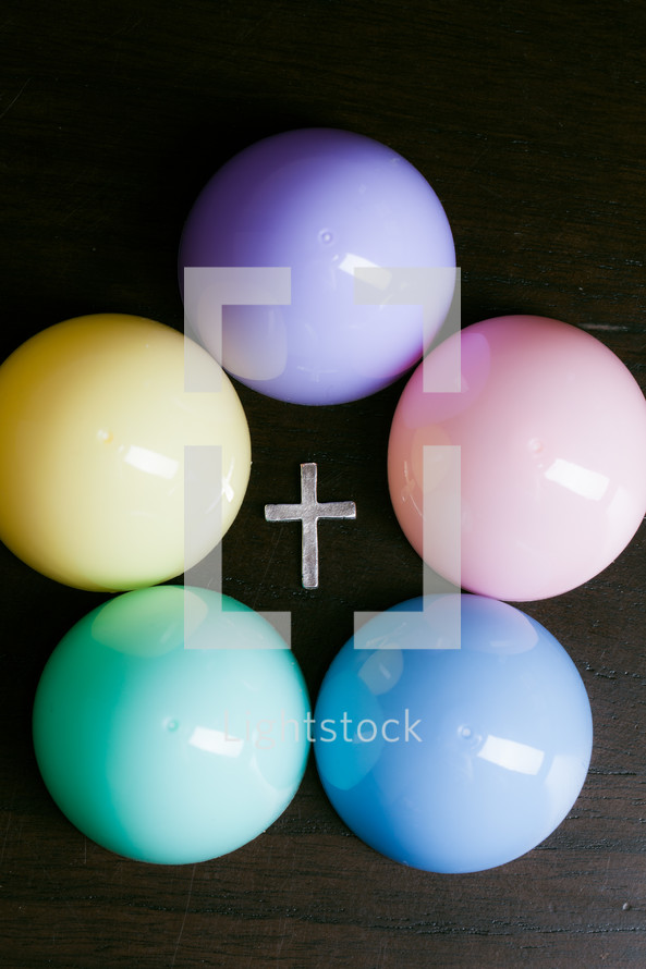 Pastel colored balls surrounding a cross.