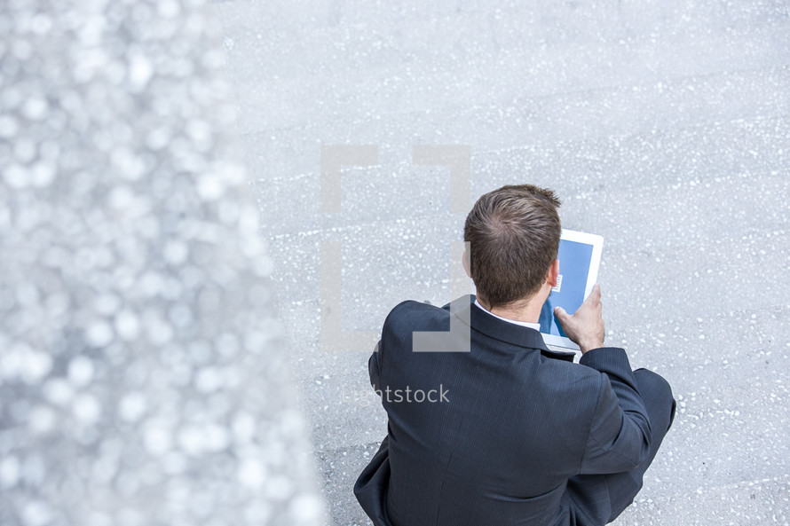 a businessman looking at an iPad screen 