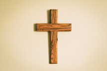 simple wood cross hanging on a wall 