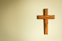 simple wood cross hanging on a wall 