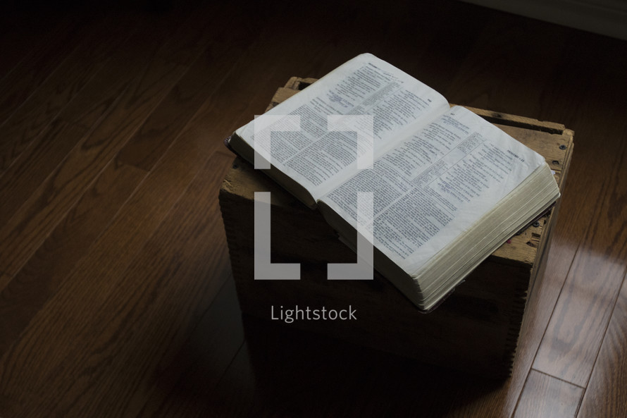 open Bible on a wood crate 