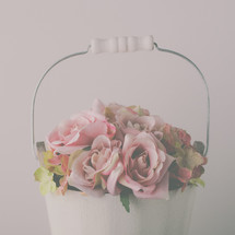 pink roses in a white pail 
