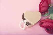 pearls in a heart shaped gift box with roses 