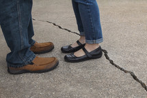 couple standing next to a crack 