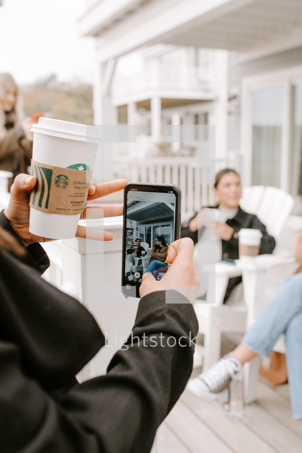taking a picture of friends with a cellphone 