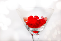 red heart pieces in a cocktail glass 