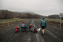 kids running on a gravel road 