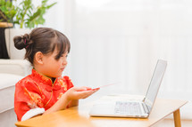 a child online looking at a computer 