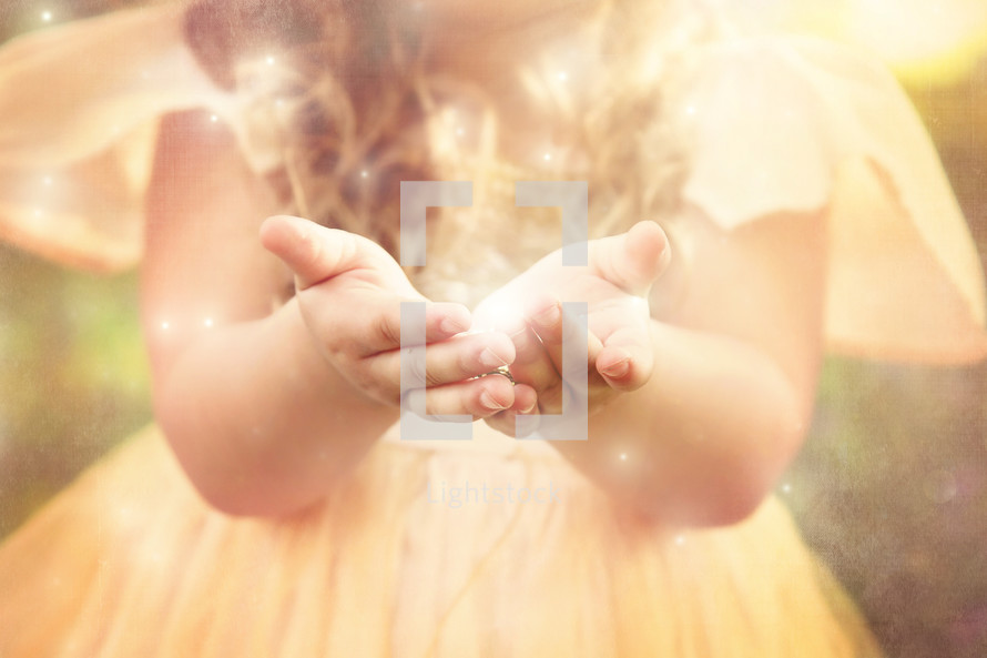 a girl holding twinkling light 