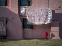 Clothesline on pink building