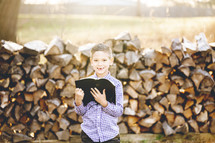 a little boy holding a Bible 