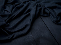 blue fabric on black wood background 