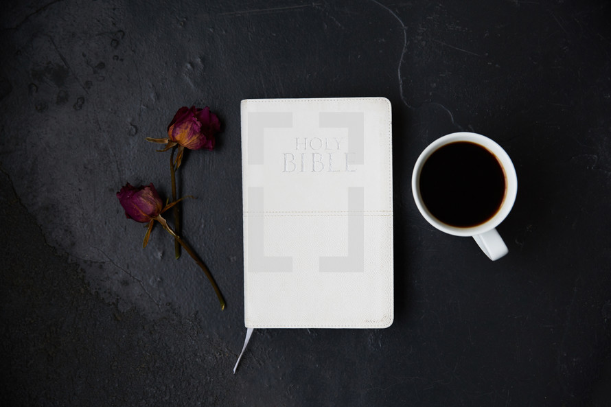 dried roses, Bible, and coffee cup 