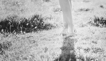 legs and feet of a woman standing in grass 