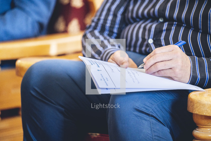 a man taking notes in his lap 