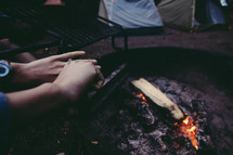 warming your hands over a campfire 