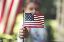 toddler boy holding an American flag 