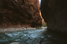 hiking along a river at the bottom of a canyon 