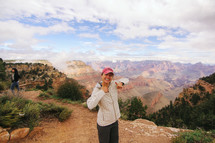 thumbs up in front of a canyon view 