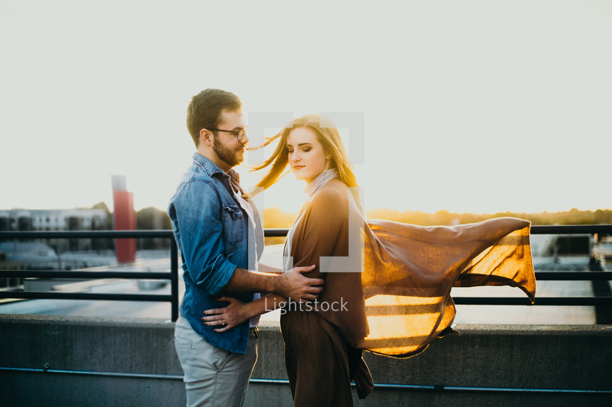 couple standing on a bridge 