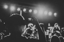 taking a picture with a cellphone at a concert 