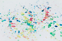 splattered colored paint on a white background 