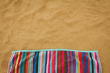 striped beach towel on the sand 