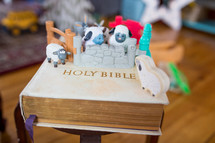 toy manger Biblical figures on a Bible 