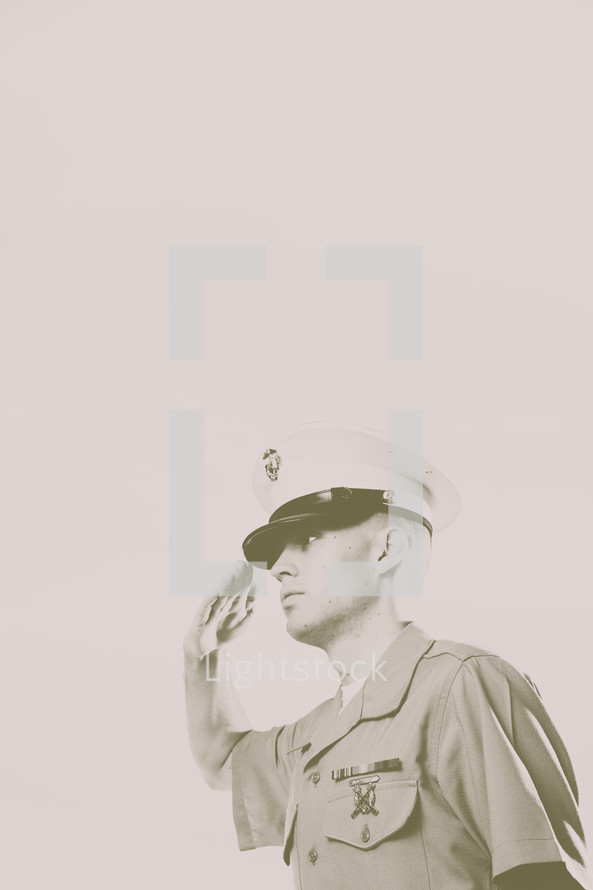 Vintage look of Marine soldier, in uniform, saluting.