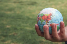 hand holding a globe 