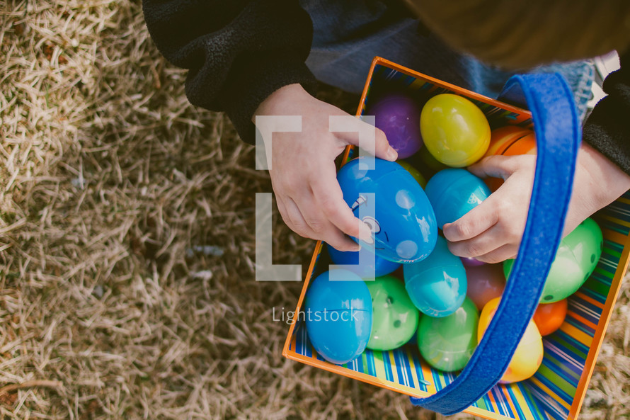 A child with a basket of easter eggs.