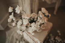 small white flowers near a marble pillar