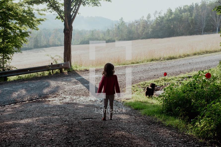 a child walking on a gravel road 