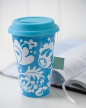 blue cup and open Bible 